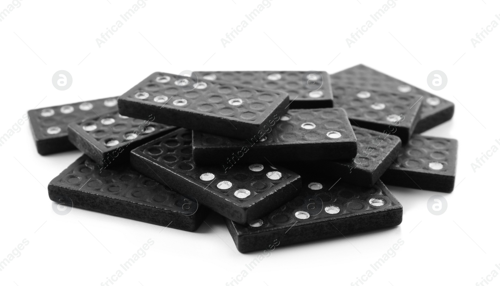 Photo of Pile of black domino tiles on white background