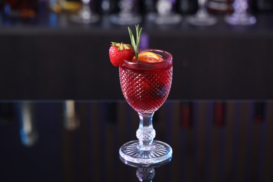 Photo of Glass of delicious refreshing sangria on counter in bar