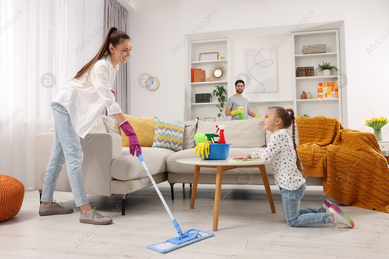 Photo of Spring cleaning. Happy family tidying up together at home