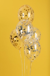 Photo of Bunch of bright balloons on color background