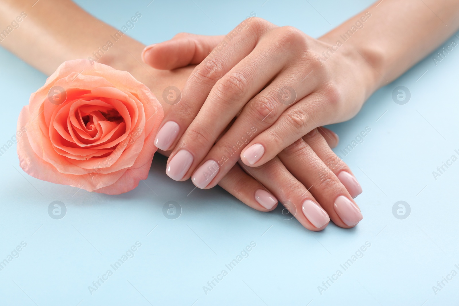 Photo of Closeup view of woman with rose on color background. Spa treatment