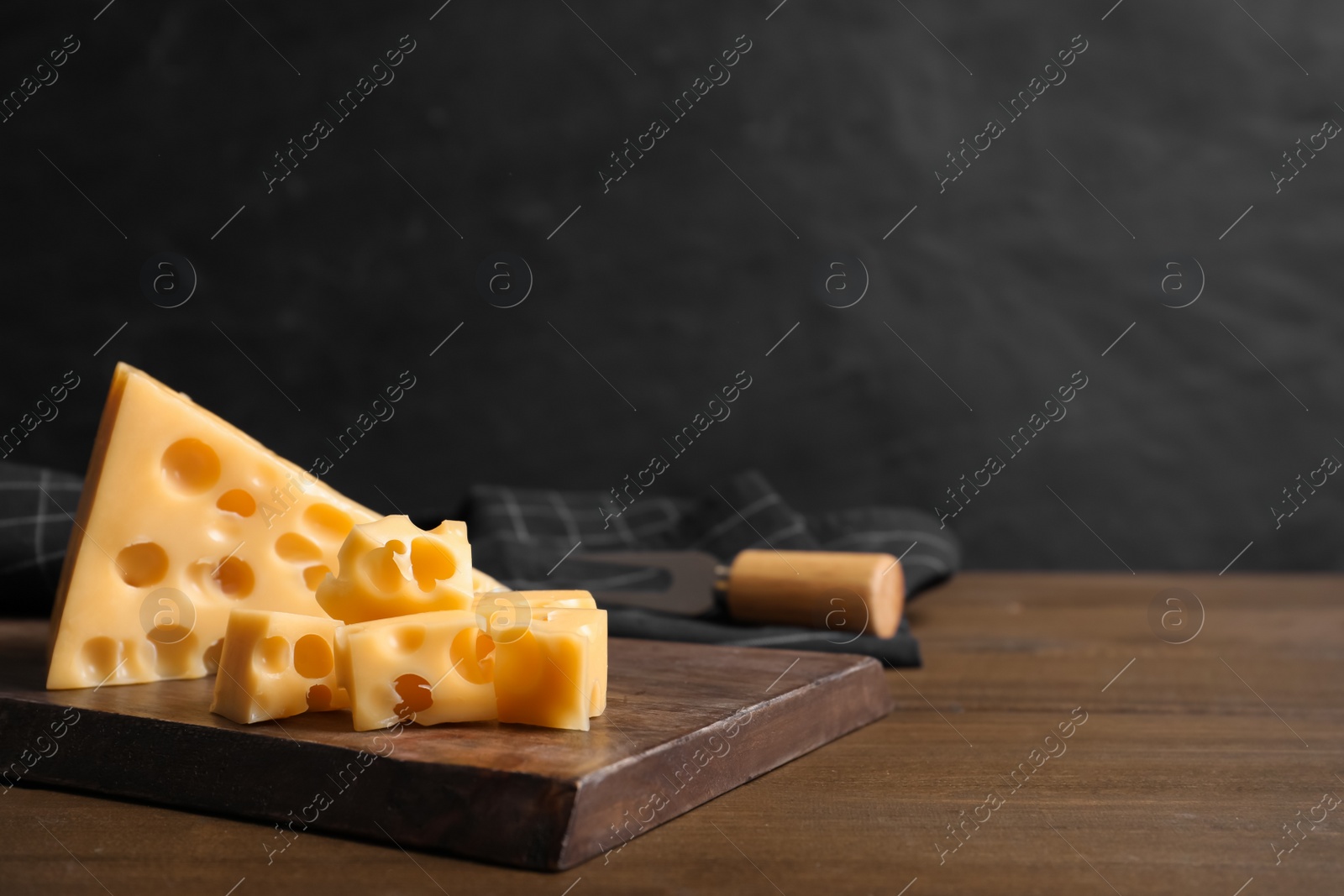 Photo of Tasty fresh cheese on wooden table, space for text