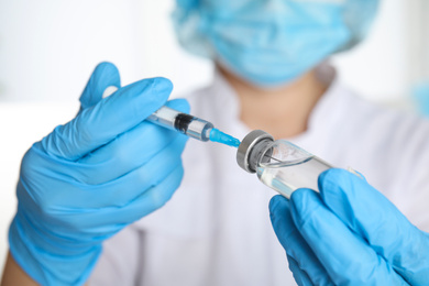 Photo of Doctor filling syringe with medication, closeup. Vaccination and immunization