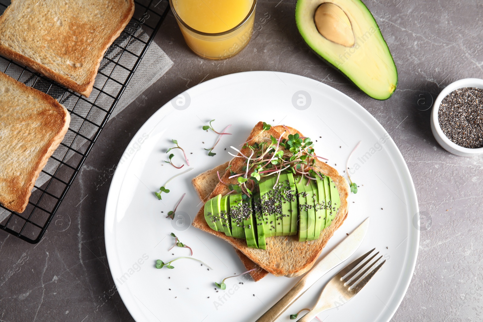 Photo of Tasty toasts with avocado, sprouts and chia seeds served on table, top view