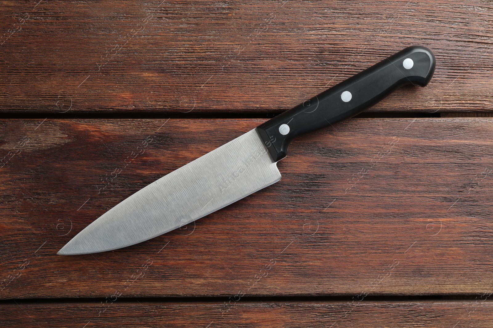 Photo of One sharp knife on wooden table, top view