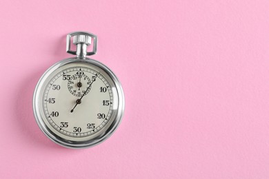 Photo of Vintage timer on pink background, top view with space for text. Measuring tool