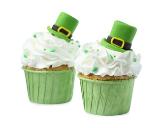 Photo of St. Patrick's day party. Tasty cupcakes with green leprechaun hat toppers and sprinkles isolated on white