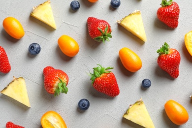 Flat lay composition with fresh berries and fruits on grey background