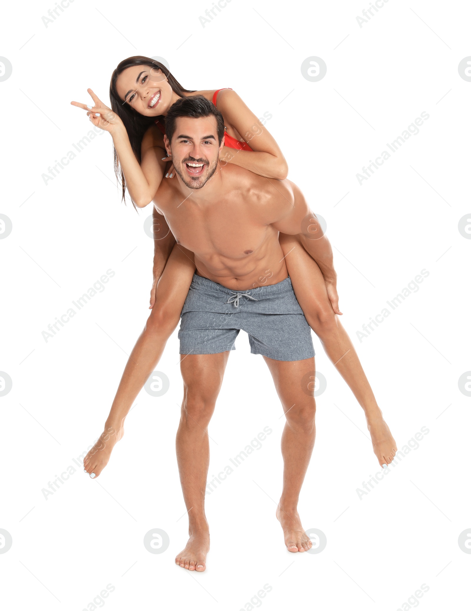 Photo of Young attractive couple in beachwear on white background