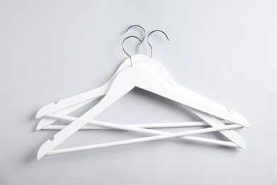 Photo of Empty clothes hangers on white background, top view