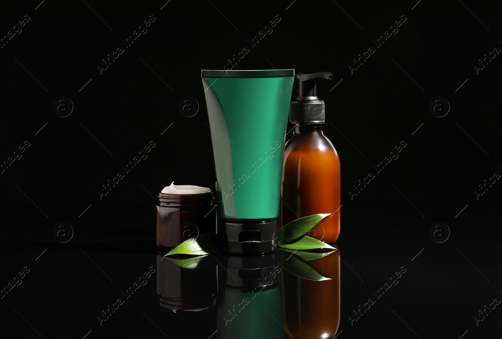 Photo of Facial cream and other men's cosmetic products on black background