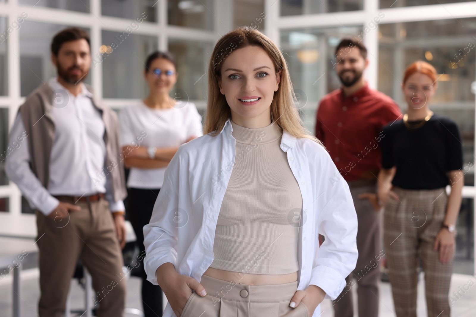 Photo of Portrait of happy businesswoman and her team in office