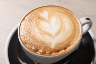 Photo of Cup of aromatic coffee on table, closeup