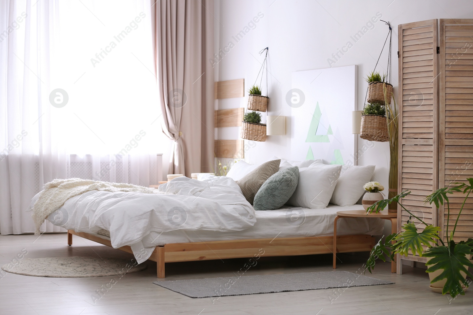 Photo of Stylish apartment with large comfortable bed. Room interior