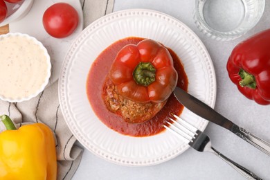 Photo of Delicious stuffed bell pepper served on light table, flat lay