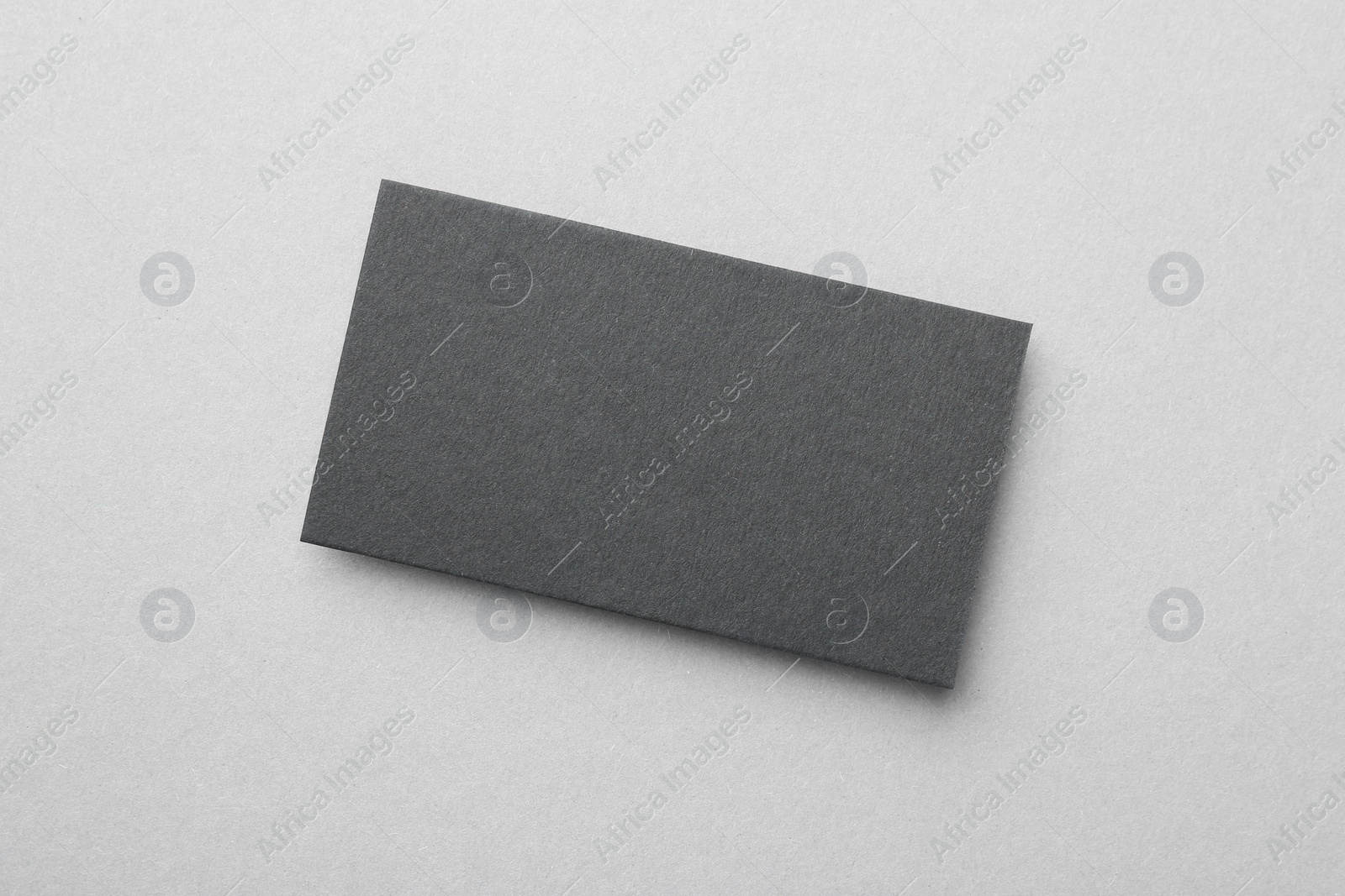 Photo of Blank black business card on light background, top view. Mockup for design