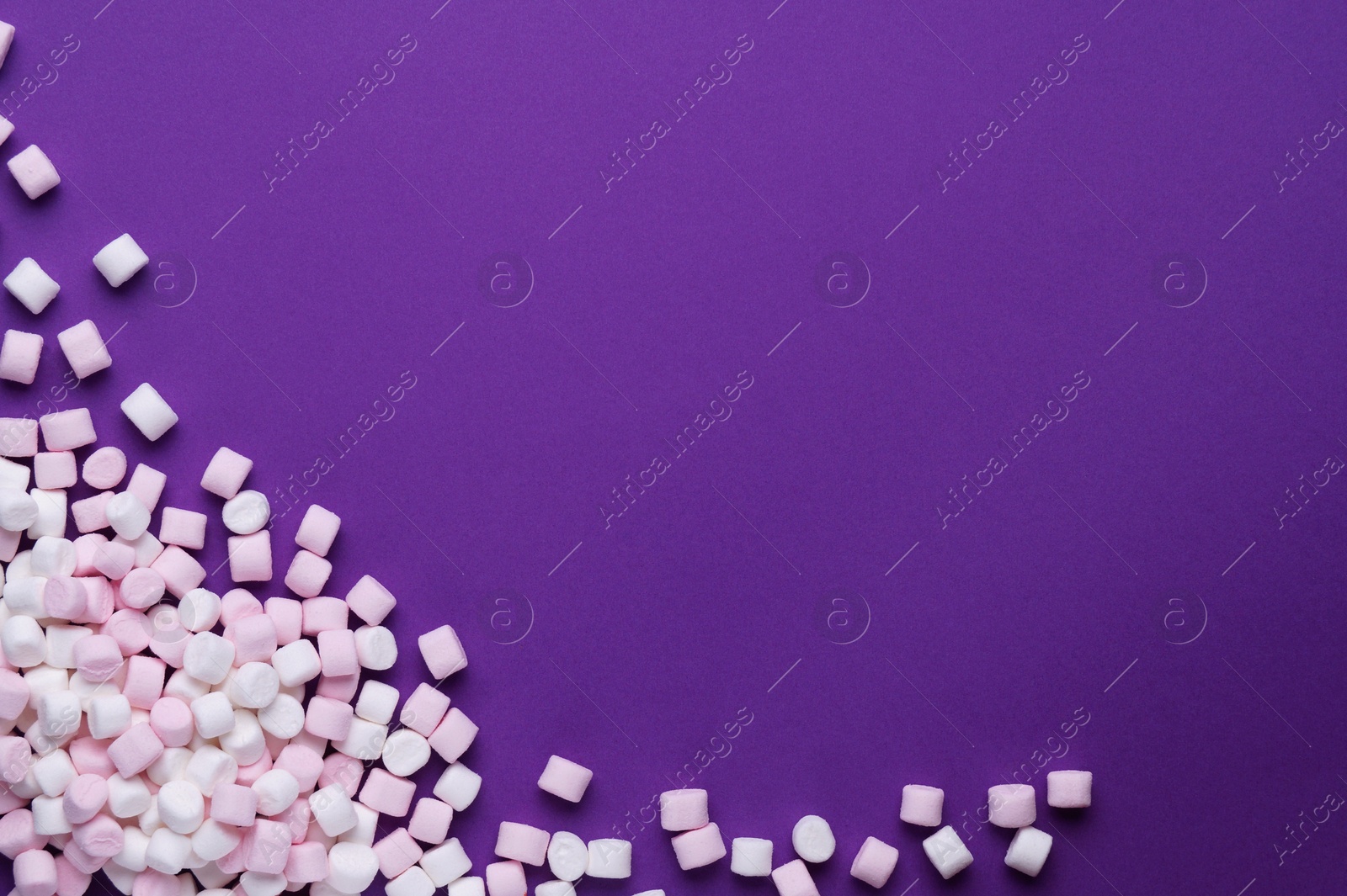 Photo of Delicious marshmallows on purple background, flat lay. Space for text