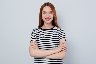 Portrait of beautiful young woman on light gray background