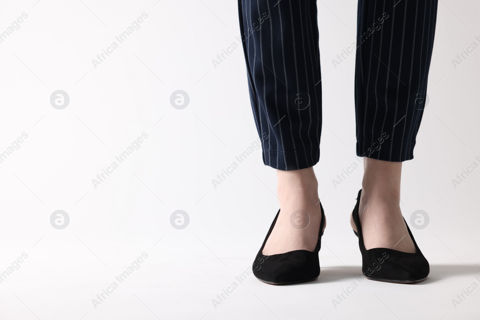 Photo of Businesswoman in black shoes on white background, closeup