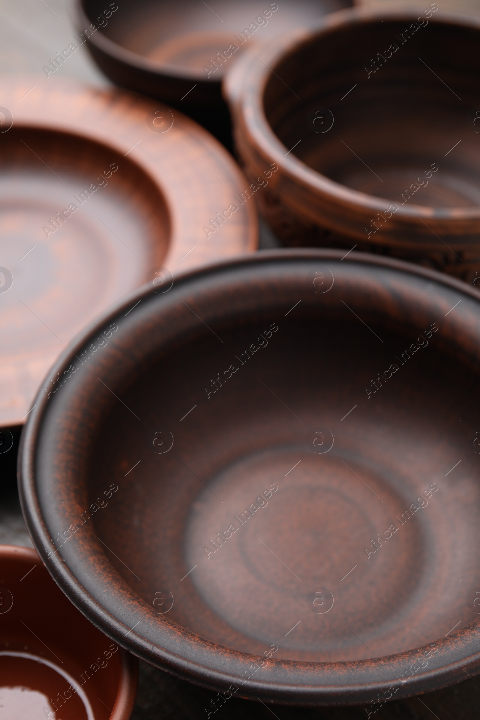 Photo of Set of clay dishes, closeup. Cooking utensils