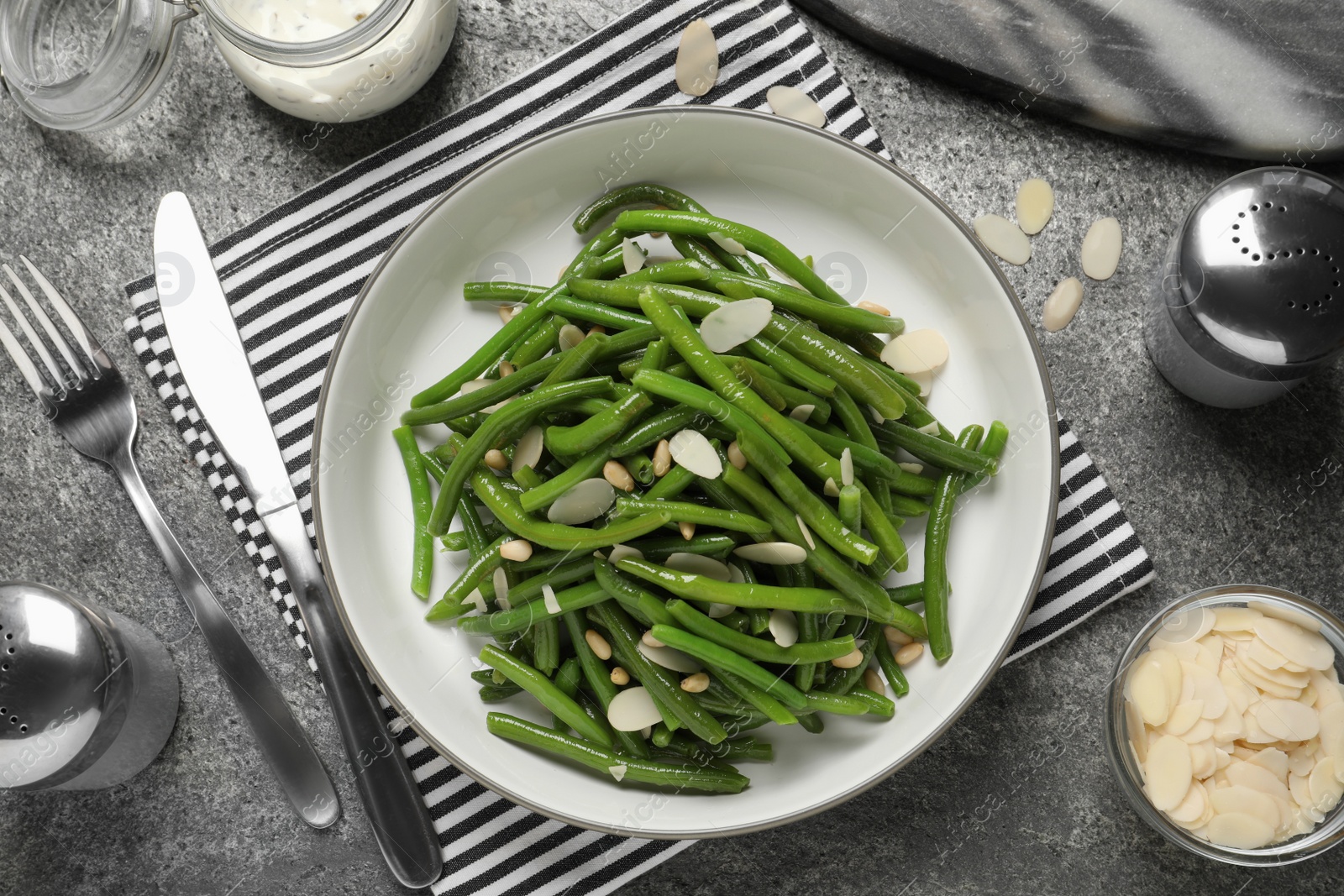 Photo of Tasty salad with green beans served on grey table, flat lay
