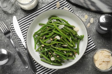 Tasty salad with green beans served on grey table, flat lay