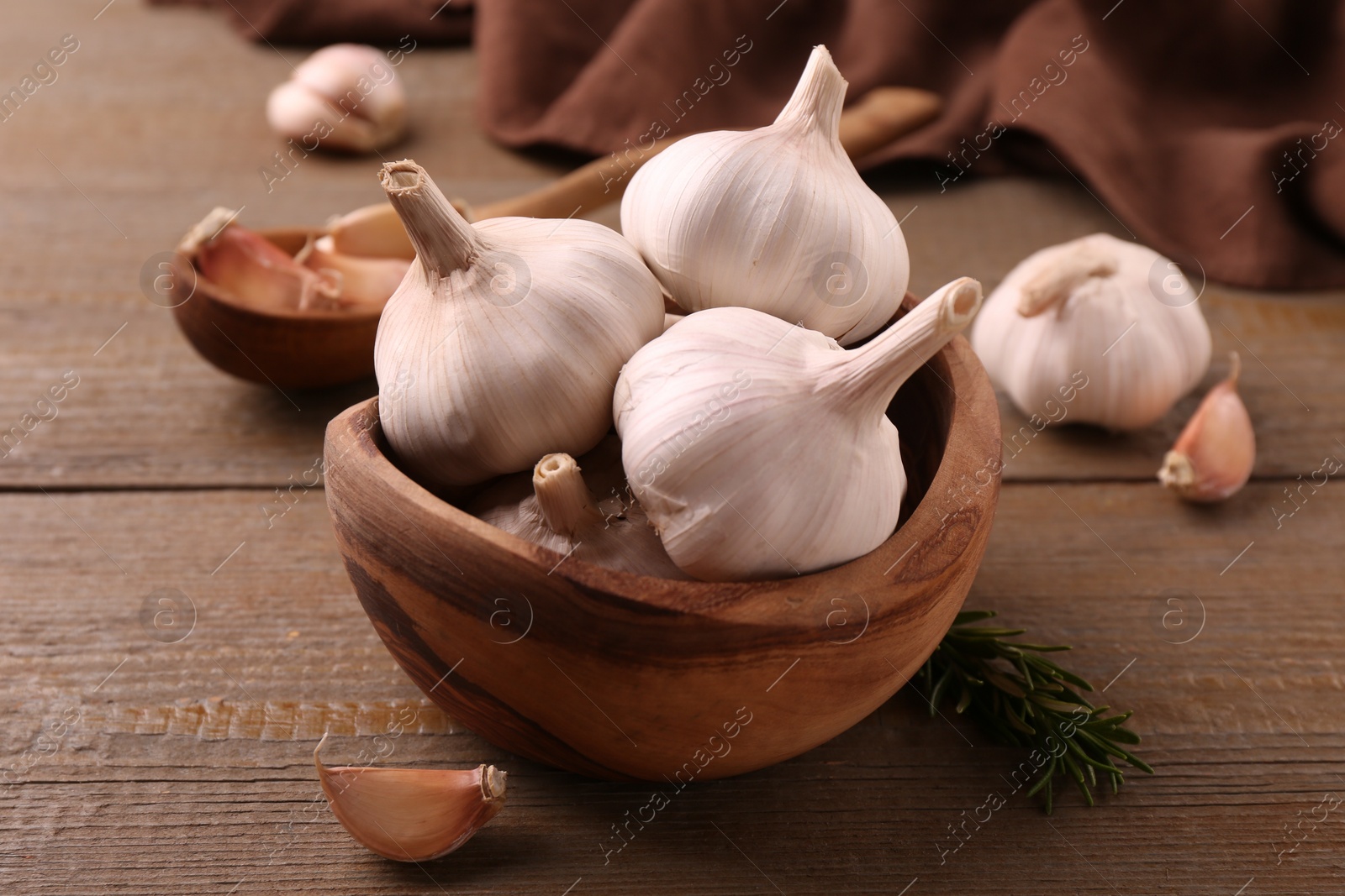 Photo of Fresh garlic on wooden table, closeup view