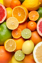 Different ripe citrus fruits as background, top view