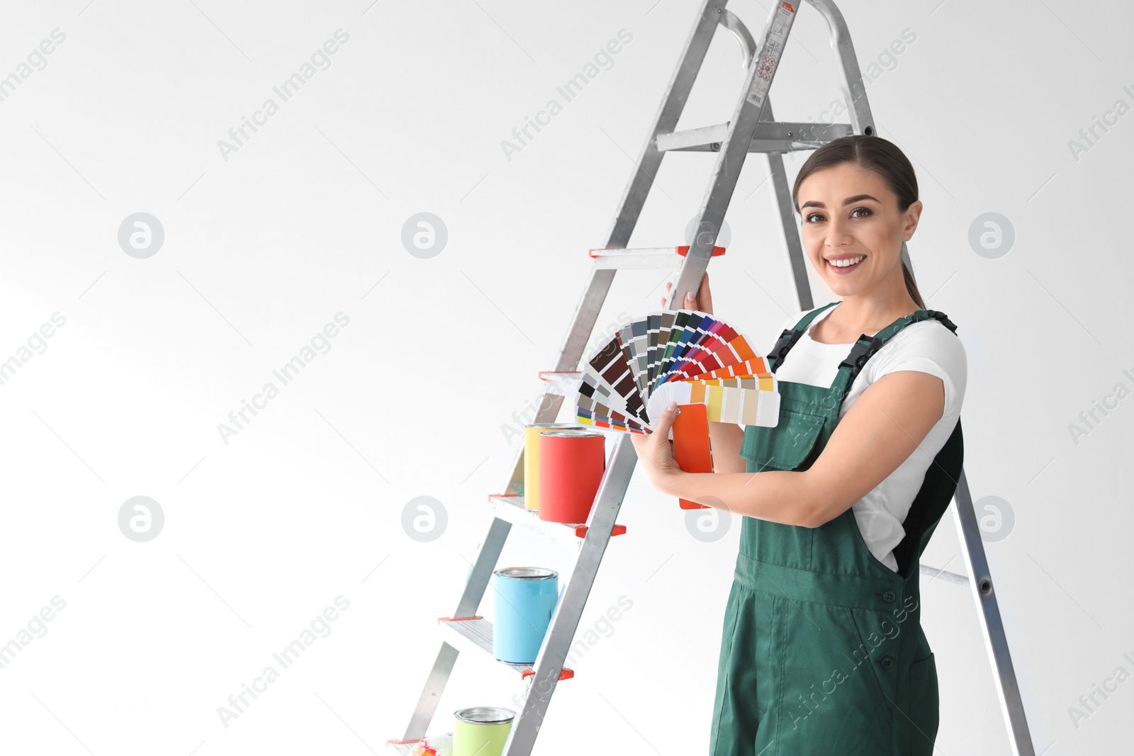 Photo of Female decorator with color palette on white background
