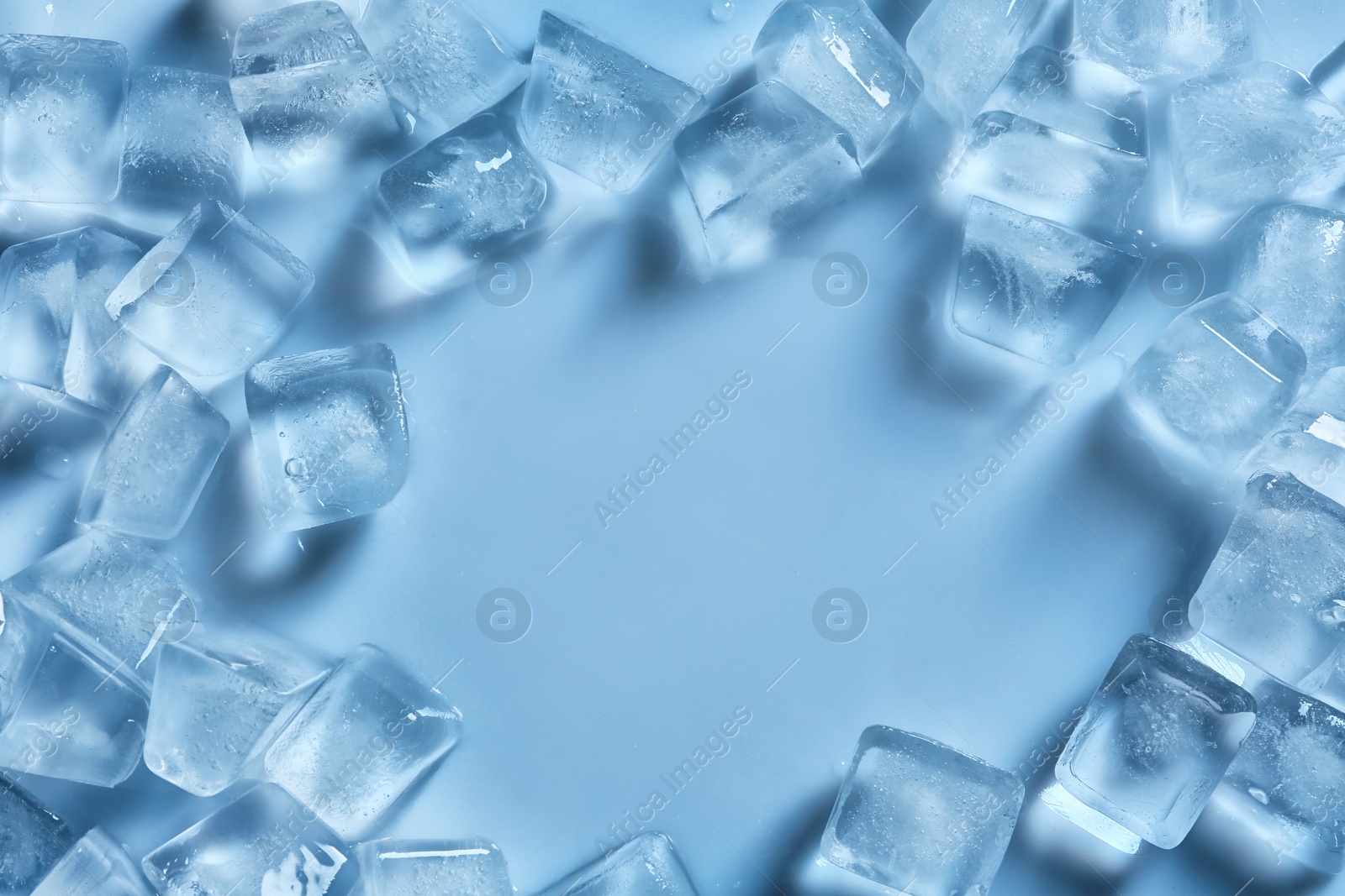 Photo of Frame made of ice cubes on color background, top view. Space for text