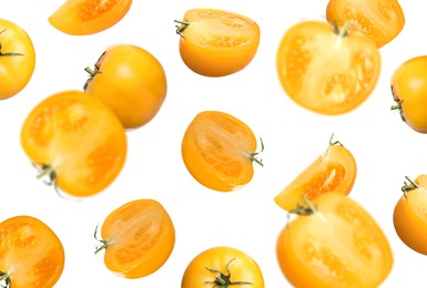 Image of Fresh ripe yellow tomatoes falling on white background