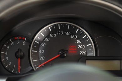 Closeup view of dashboard with warning icon check airbag system in car