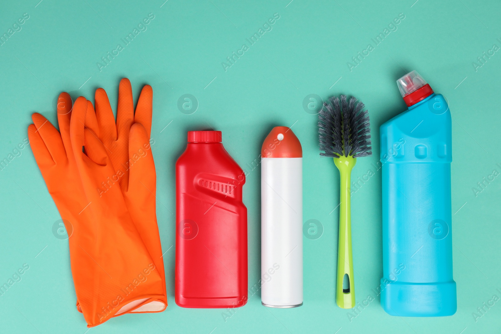 Photo of Set of cleaning supplies on color background