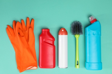 Photo of Set of cleaning supplies on color background