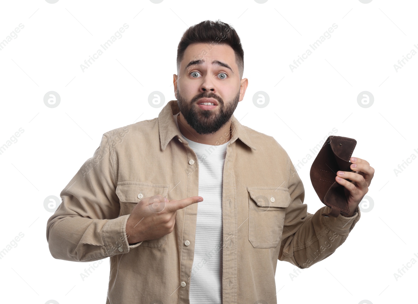 Photo of Confused man pointing at empty wallet on white background