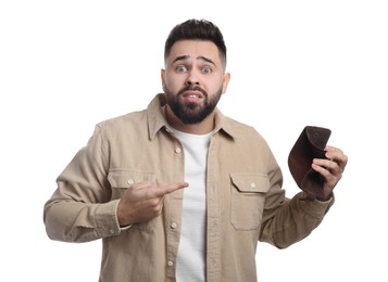 Photo of Confused man pointing at empty wallet on white background