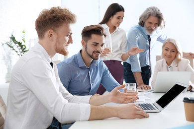 Photo of Business people discussing work matters in office. Professional communication