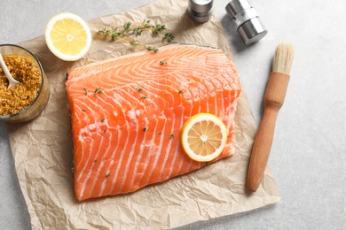 Photo of Raw salmon fillet and ingredients for marinade on table, top view