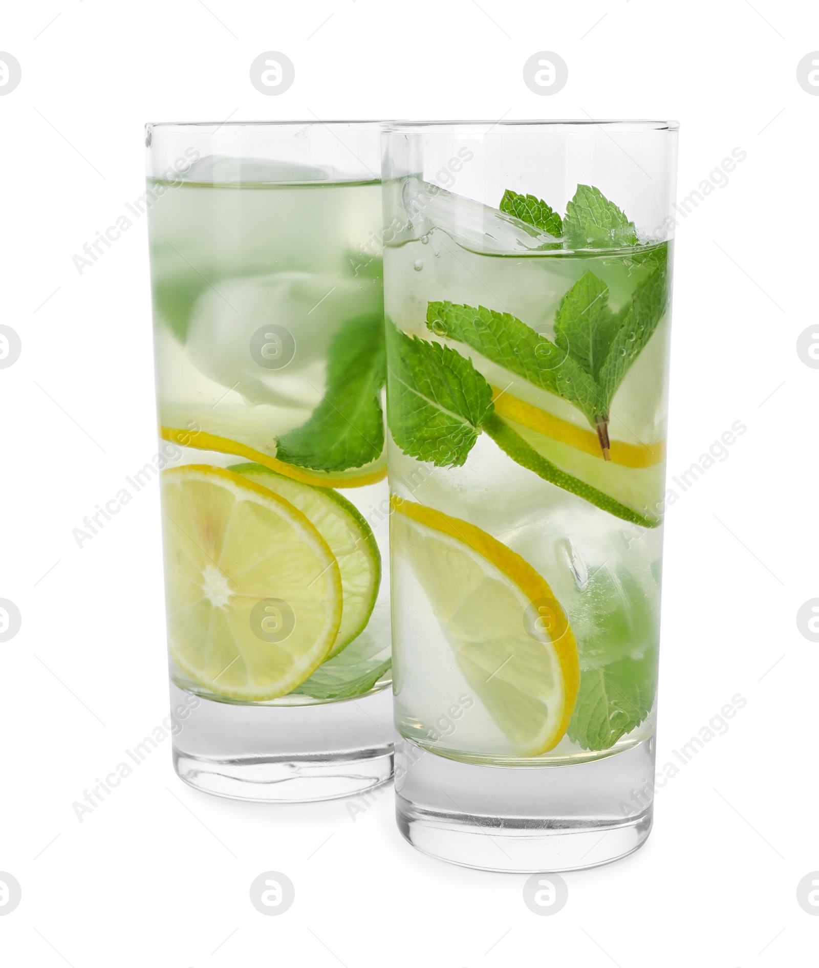 Photo of Glasses of refreshing drink with citrus slices and mint on white background