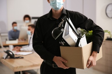 Photo of Dismissed man carrying box with stuff in office, closeup