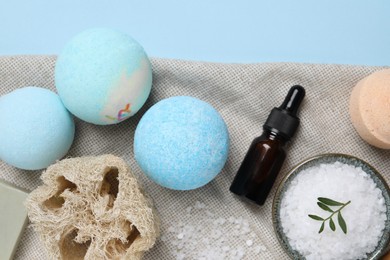 Flat lay composition with bath bombs on light blue background