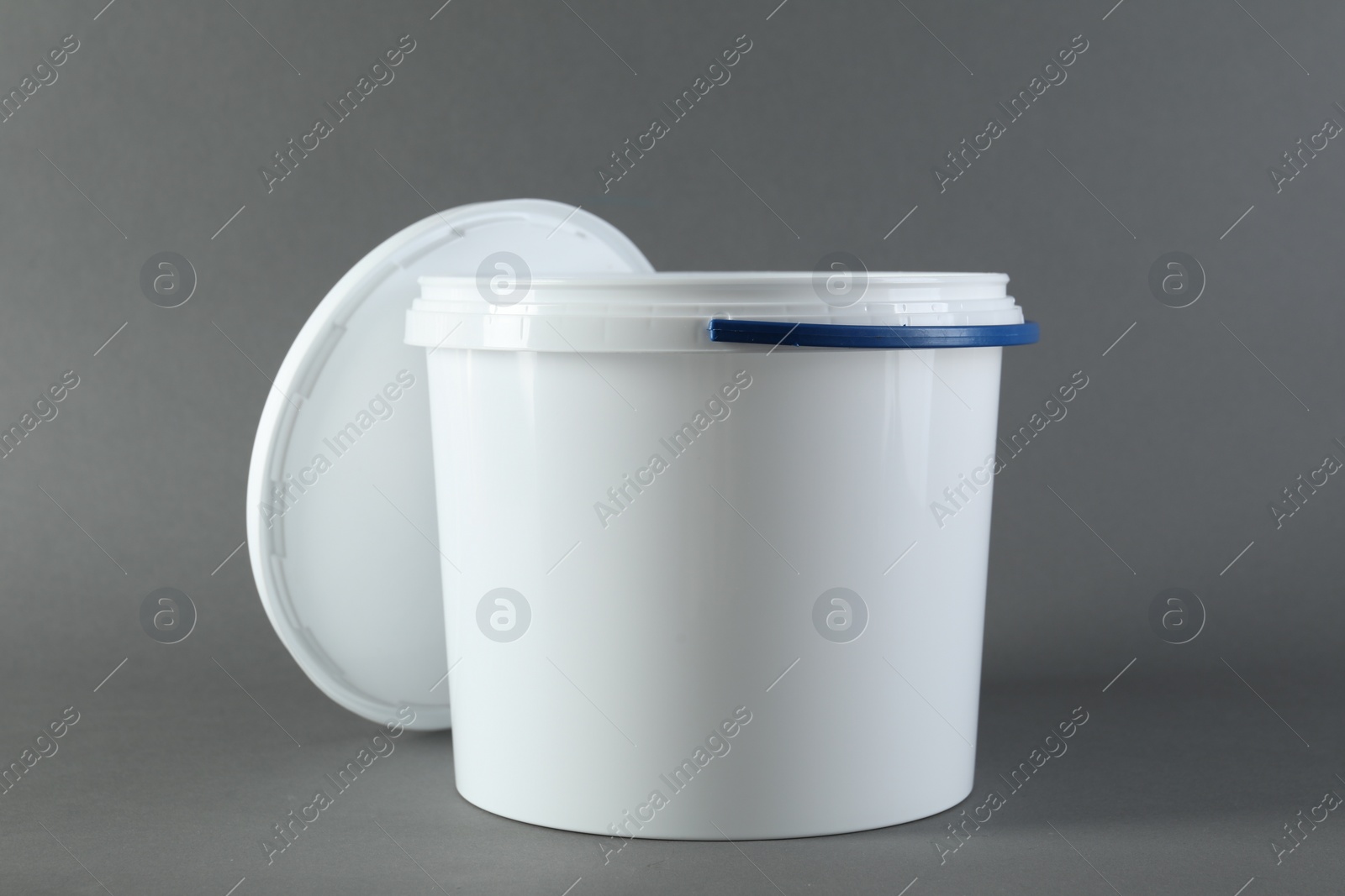 Photo of One plastic bucket and lid on grey background