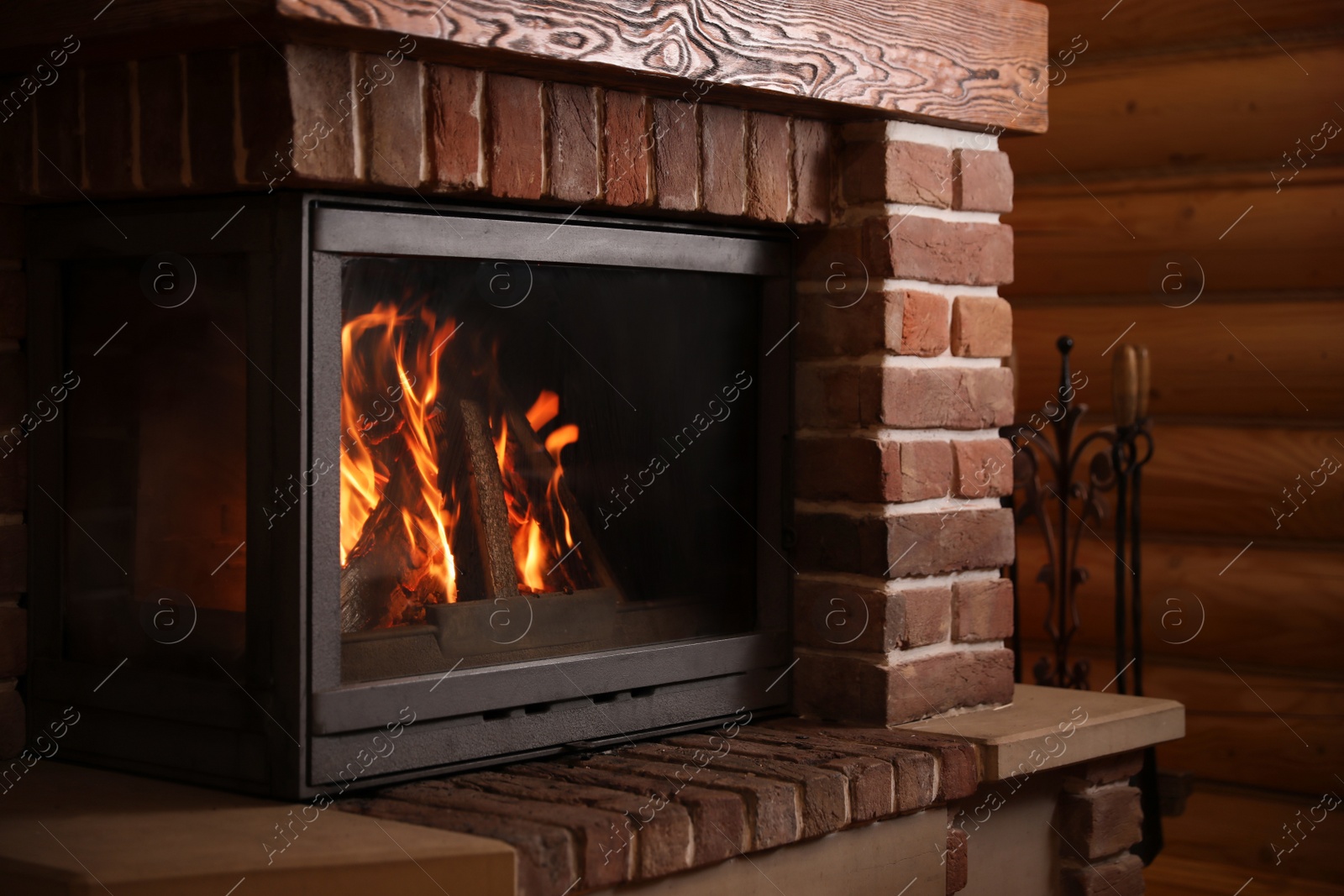 Photo of Fireplace with burning wood indoors. Winter vacation