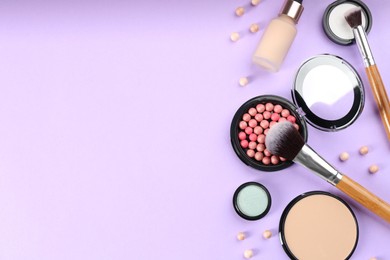 Photo of Flat lay composition with makeup brushes on violet background, space for text