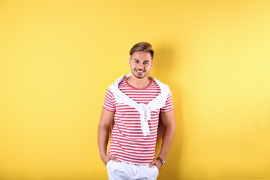 Photo of Young man with trendy hairstyle on color background