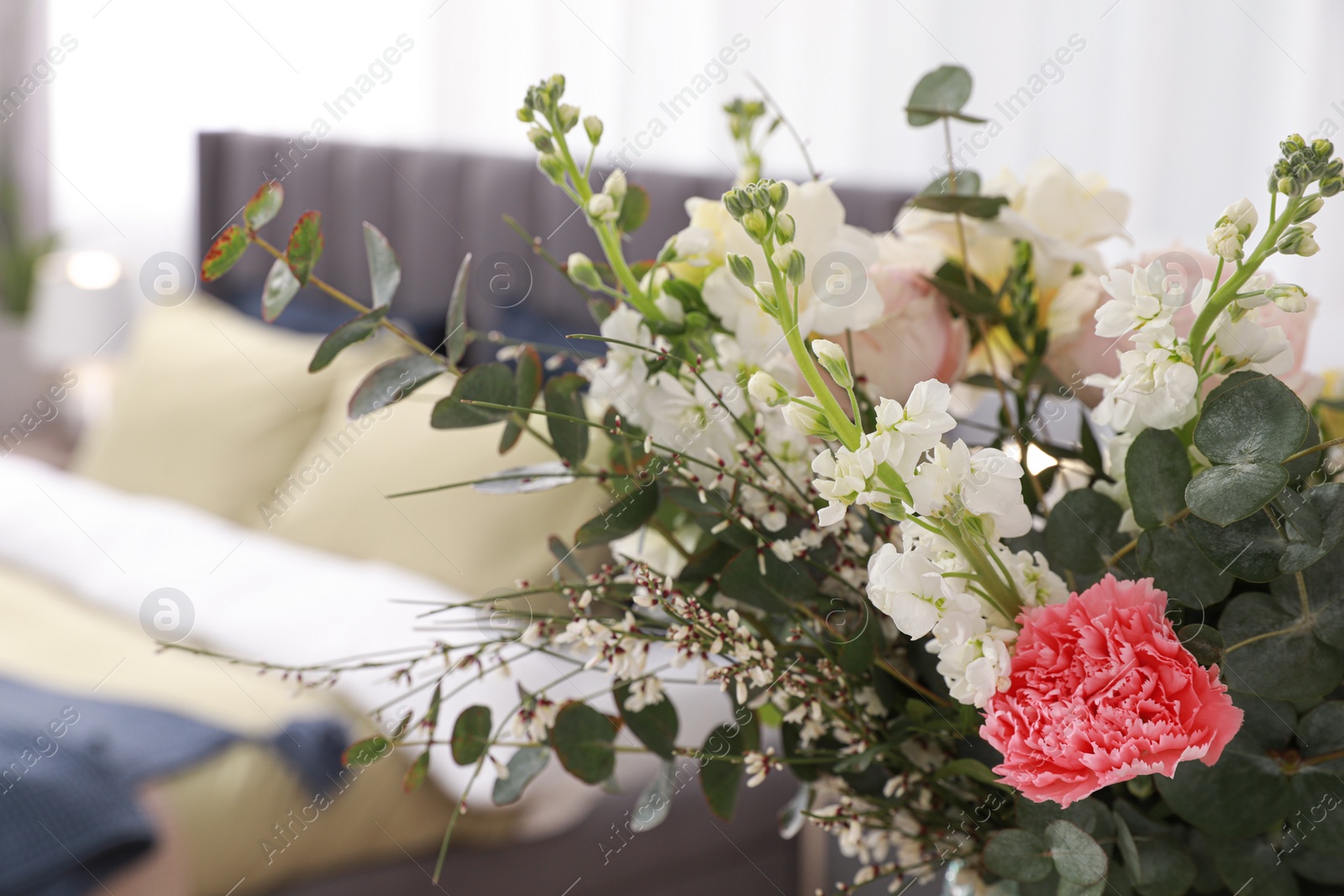 Photo of Beautiful bouquet of flowers in room, space for text