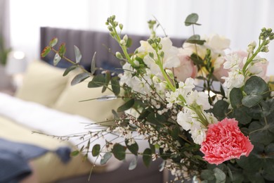 Beautiful bouquet of flowers in room, space for text