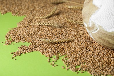 Photo of Globe and grains on light green background. Space for text. Hunger crisis concept