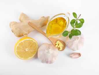 Composition with garlic and other cold remedies on white background, top view