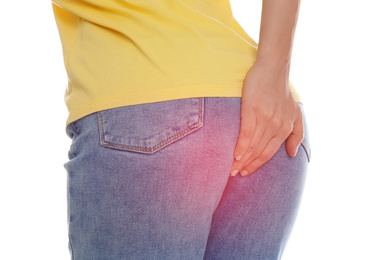 Image of Woman suffering from hemorrhoid on white background, closeup